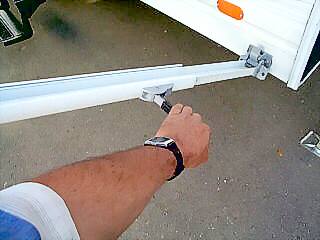 Lifting on the handle releases the lock so you can raise the RV awning